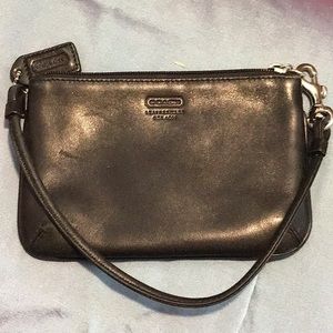 Coach black leather wristlet, small about 6” by 4”. Excellent condition
